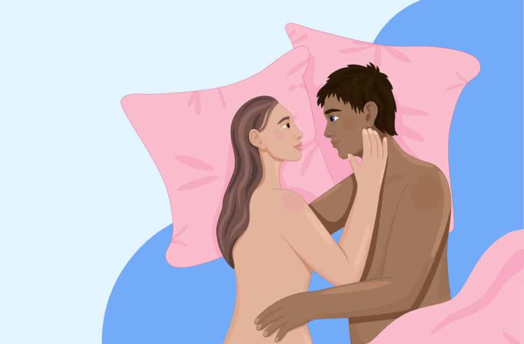 Couple in bed embracing, exploring the concept of using a pillow to get pregnant.