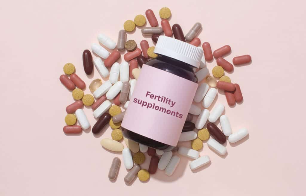 Colorful pills and a bottle labeled "Fertility supplements".