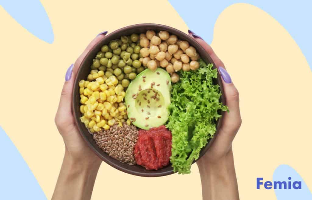 Photo of a healthy meal plate with greens, avocado, chickpeas, corn, and other nutritious ingredients.