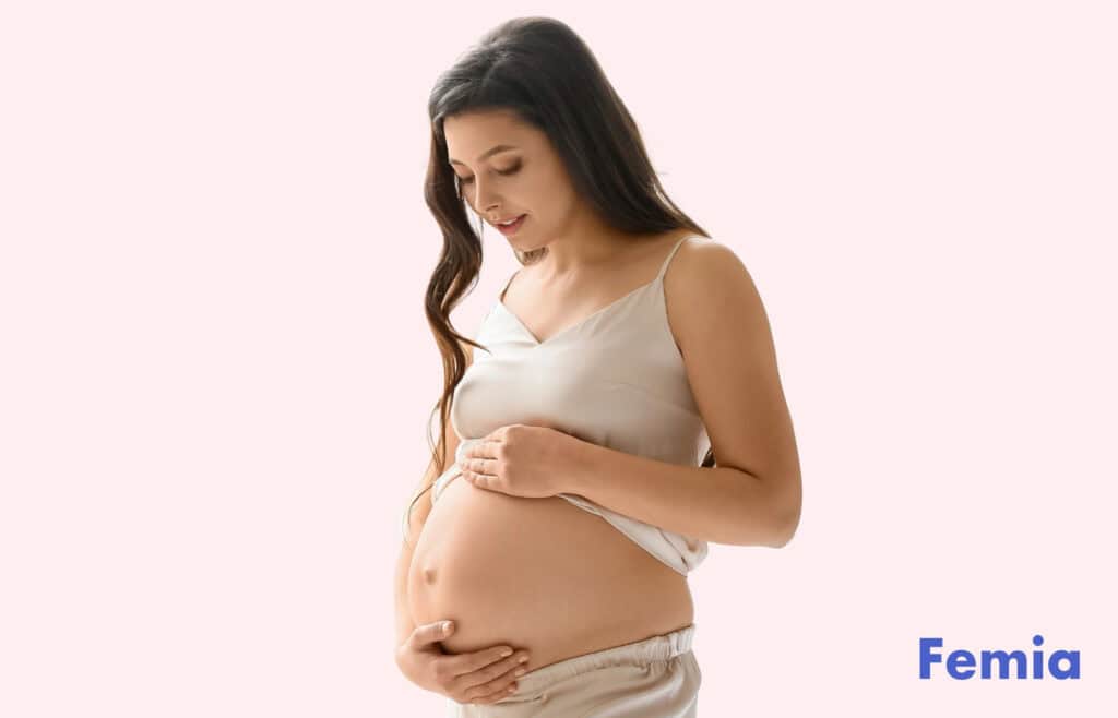 Photo of a pregnant woman touching her belly.