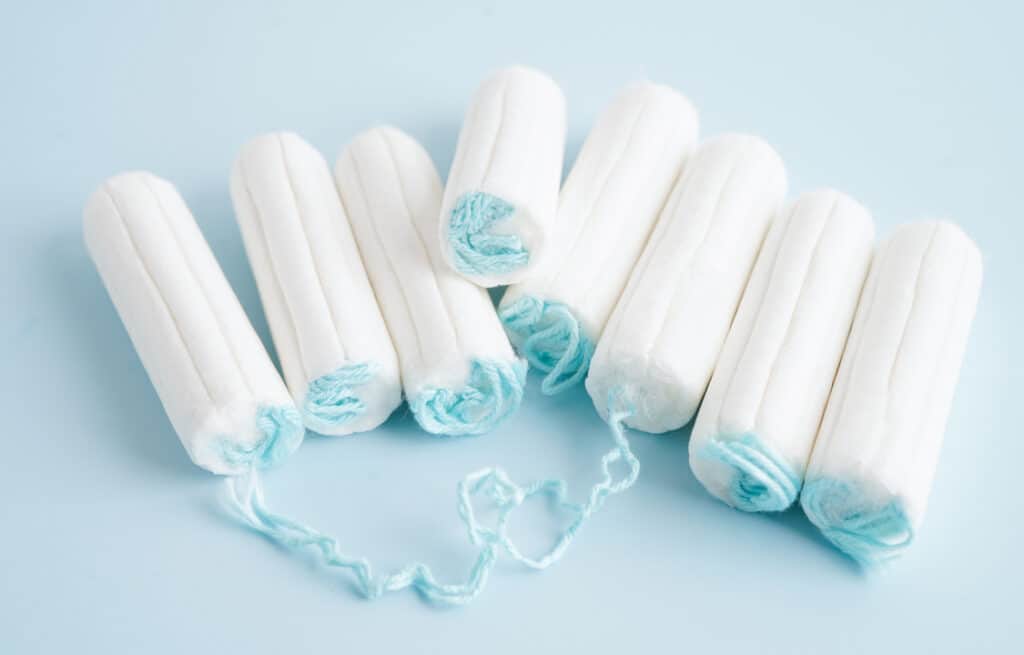 A row of tampons on a blue background.