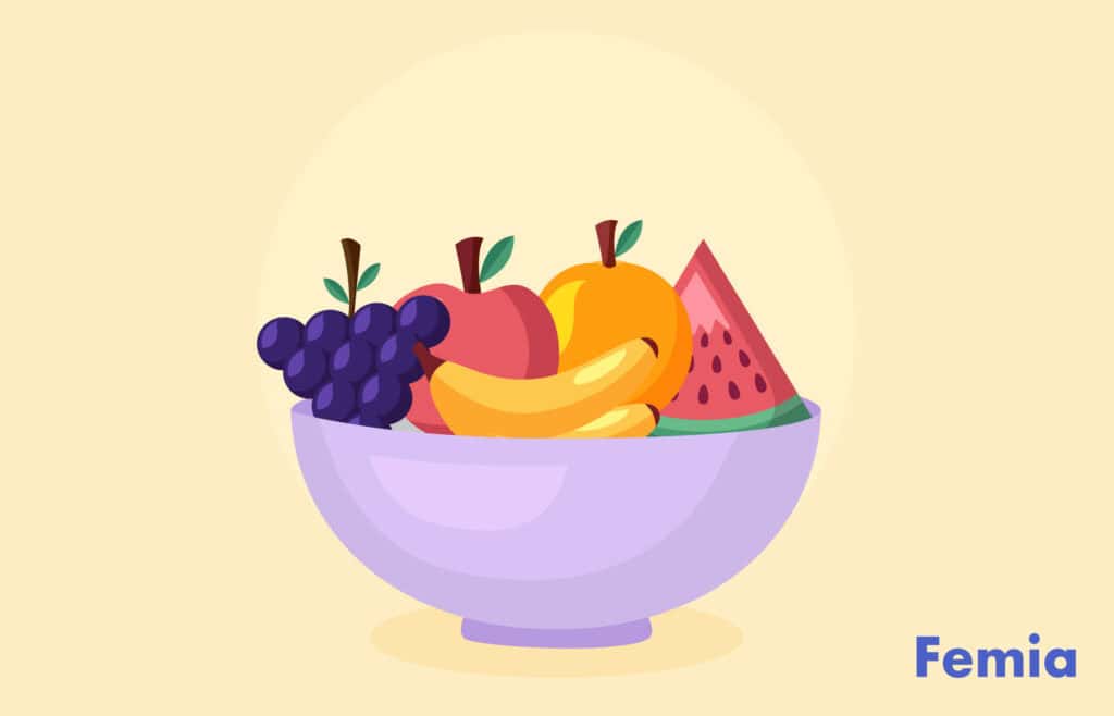 Bowl of mixed fruits including grapes, apples, bananas, and a watermelon.