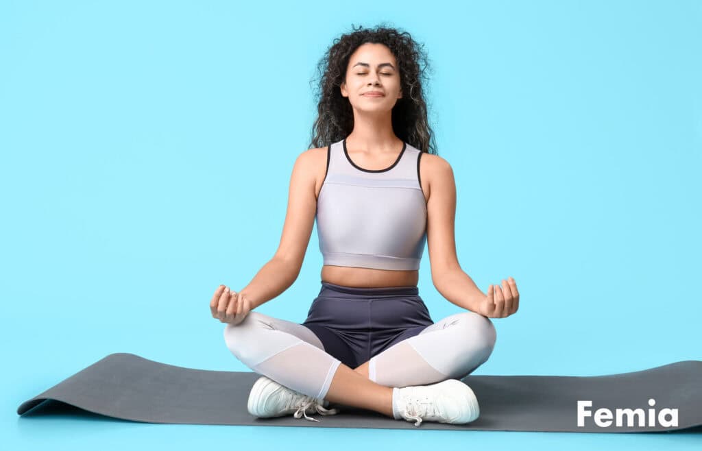 A woman on a yoga matt representing a healthy lifestyle as an indicator of fertility.