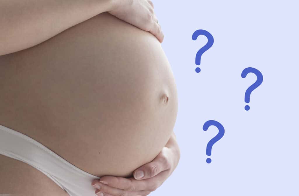 A photo of a pregnancy belly with question marks representing cryptic pregnancy symptoms.