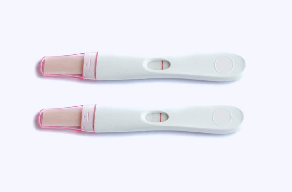 An image of two pregnancy tests: one is negative and another one is faint positive.