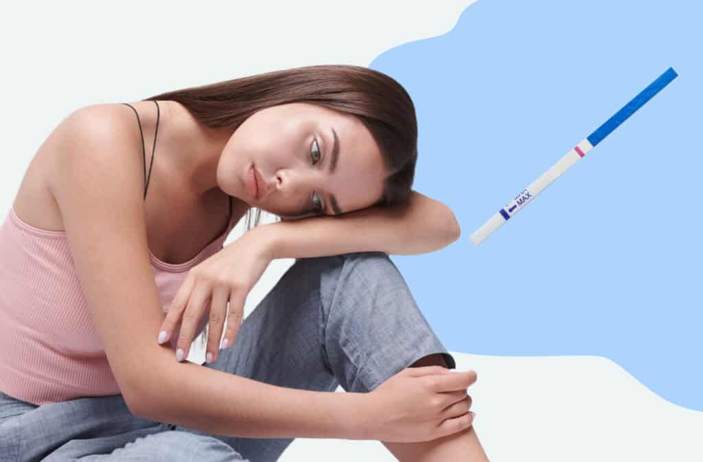 A photo of a sad girl and a negative ovulation test representing not ovulating but still having periods.