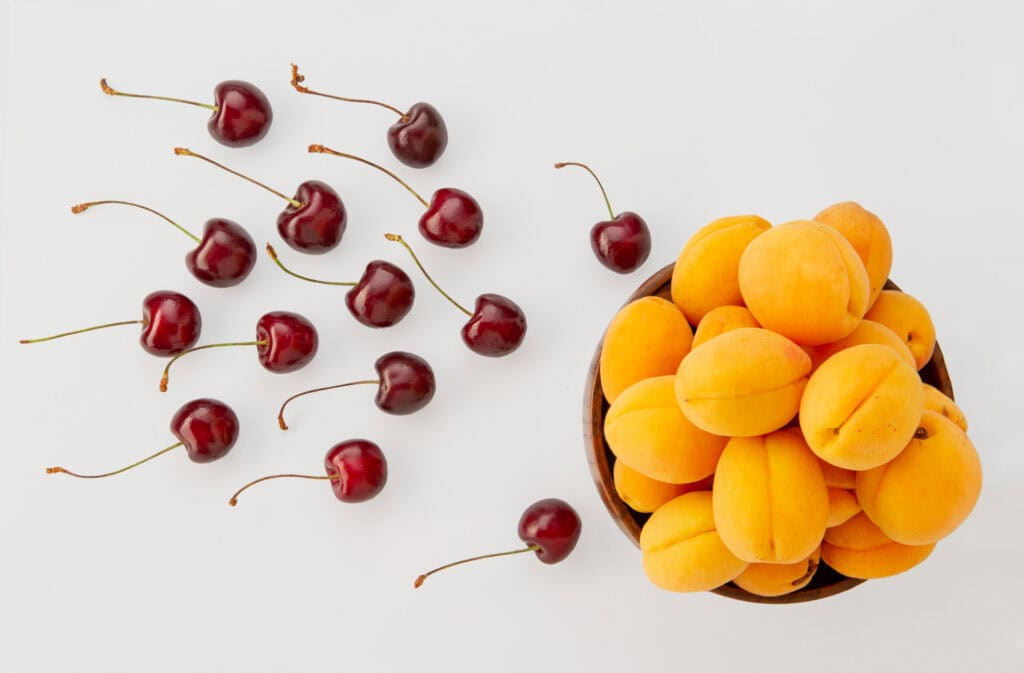 An image of cherries going towards apricots representing fertility.