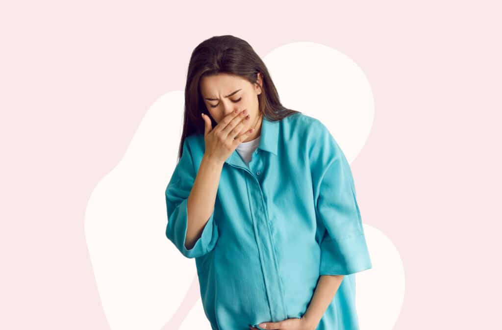 An image of a pregnant woman covering her mouth with a hand representing a third-trimester nausea.