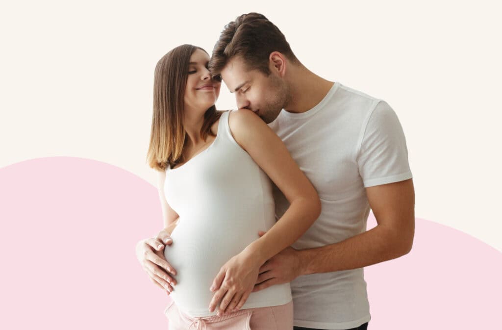 A photo of a man hugging a pregnant woman representing best sex positions to induce labor.