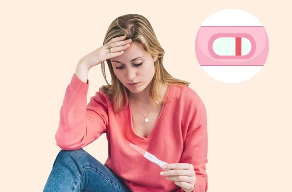 A photo of a woman holding a negative pregnancy test and wondering why am I not getting pregnant?